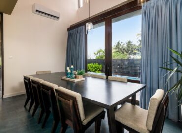 Dining table with view of the pool of the villa