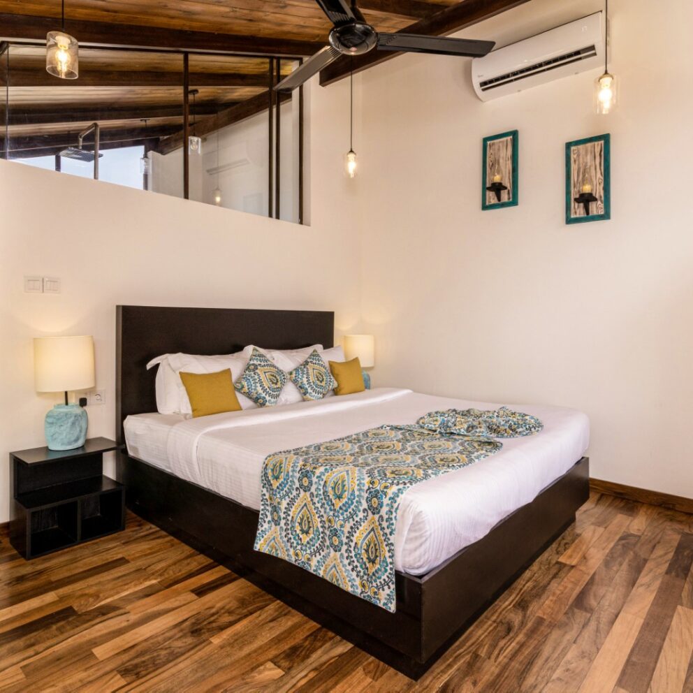 Bedroom with elegant wooden flooring and a stylish ceiling fan