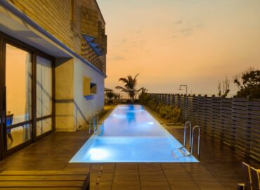 Beach Villa private pool with the patio area in the evening.