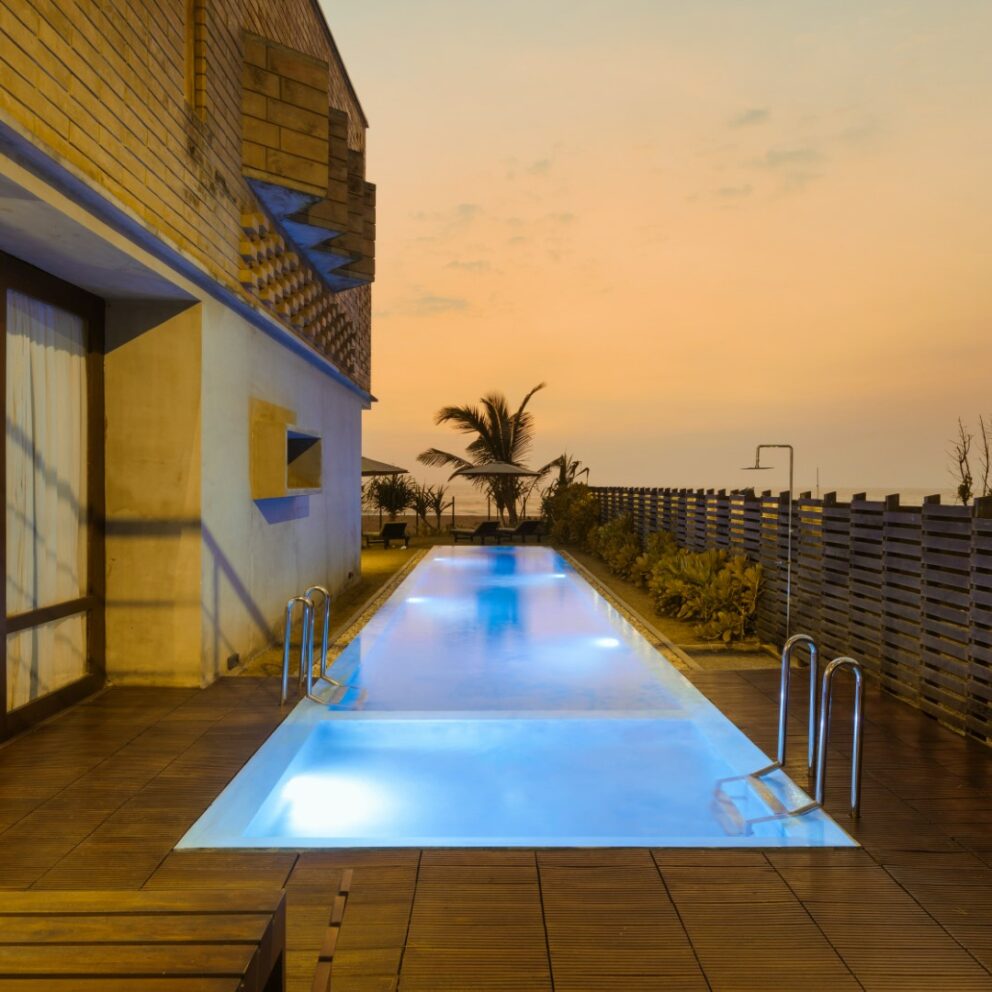 Beach Villa private pool with the patio area in the evening.