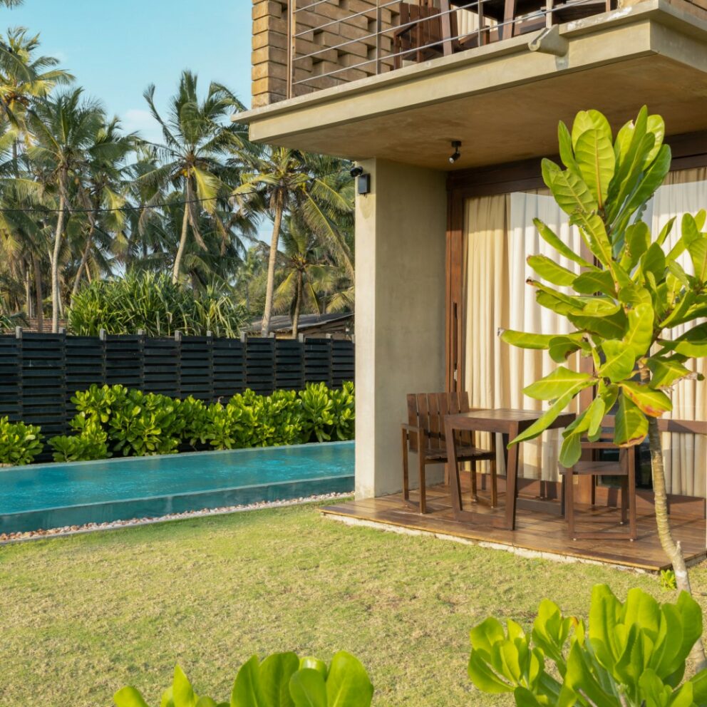 Tables arranged in the seating areas of the villas.