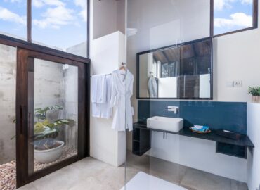 Bathroom arranged with Bathrobes Bath towels and other amenities