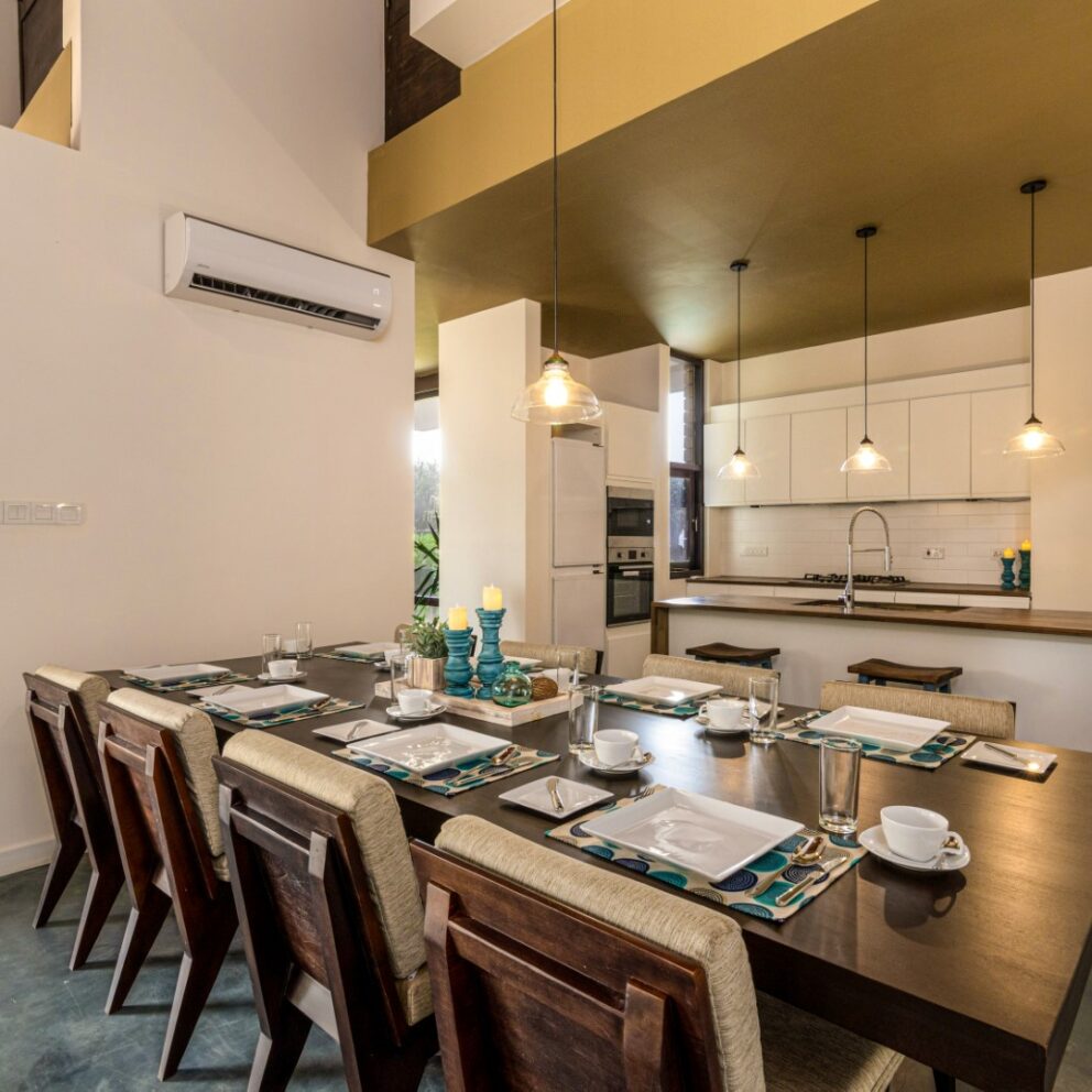 The kitchen area with arranged dining table and chairs