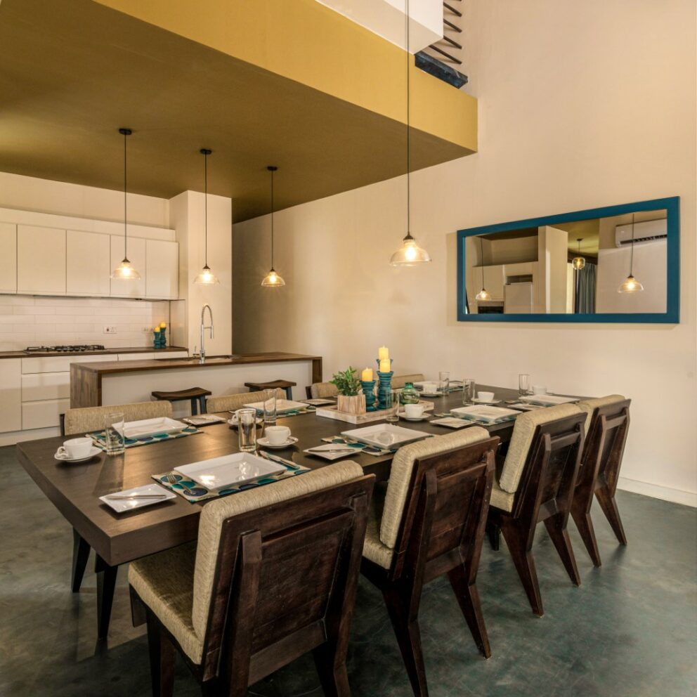 The kitchen area with arranged dining table and chairs